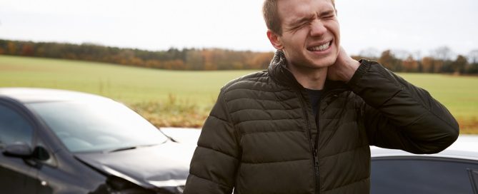 Man Suffering With Whiplash Injury After Car Accident