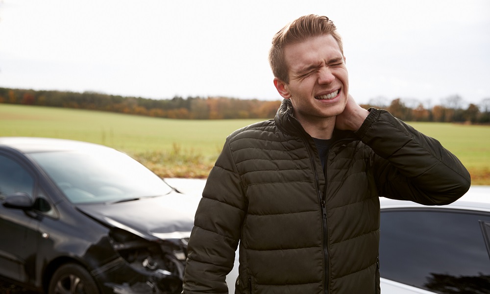 Man Suffering With Whiplash Injury After Car Accident